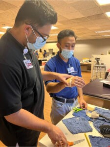 Photo of a student at CBD College studying to become a Physical Therapist Assistant, actively participating in hands-on training and learning.