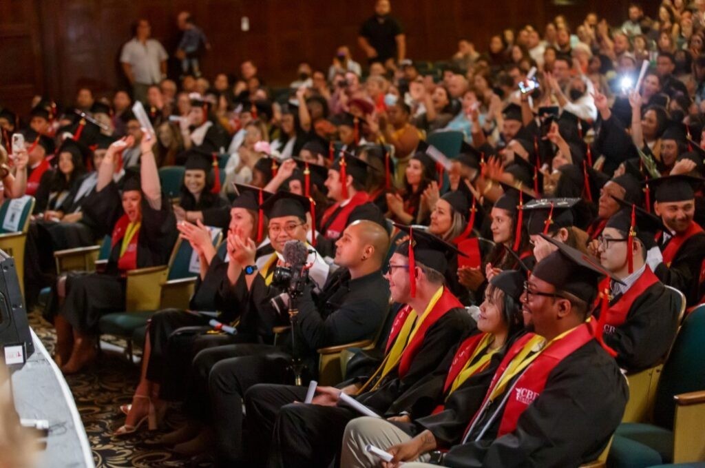 The auditorium is brimming with joy as numerous graduating students from CBD College gather, radiating cheerfulness and happiness as they mark the culmination of their educational journey. Proud families and friends fill the seats, witnessing their sons' and daughters' accomplishments with admiration and support.