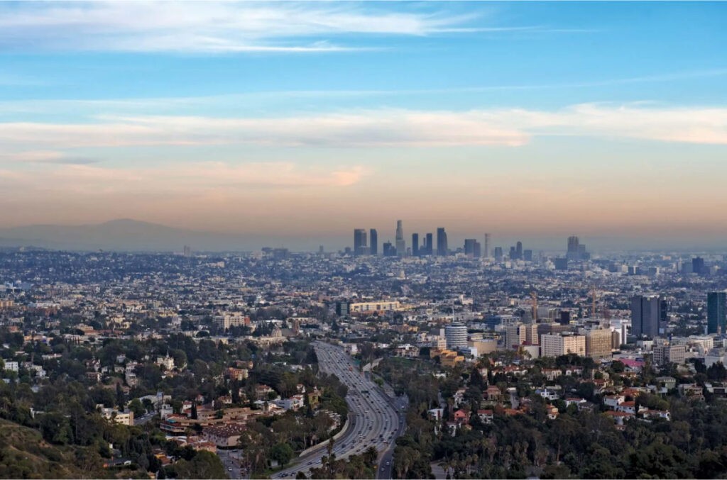 An aerial photograph captures the sprawling cityscape of Los Angeles, California, United States, showcasing the vibrant urban landscape. Amidst the bustling streets and towering skyscrapers.