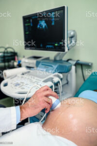 Diagnostic Medical Sonography: Image of a sonographer performing an ultrasound examination on a patient.