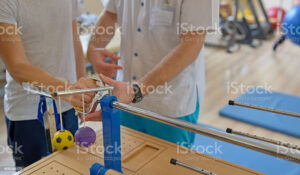 Occupational Therapy Assistant: Picture of an occupational therapy assistant working with a patient on rehabilitation exercises.