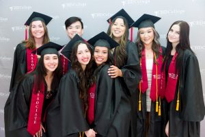 CBD College graduates celebrating their achievements, smiling and posing for a photo together.
