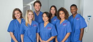 Image of students from CBD College in a hospital setting, smiling.