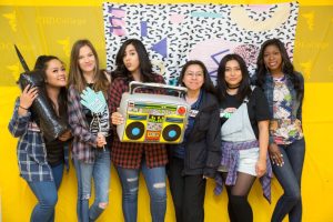 CBD College students pose with a giant boombox as part of the 90s-themed Student Appreciation Day.