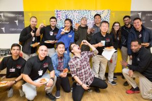 CBD College students and staff gather for a group photo, commemorating the fun-filled 90s-themed Student Appreciation Day in March 2018.