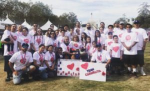 Ambassador students gather together, holding signs in support of ALS awareness.