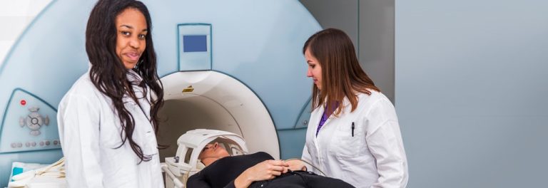 MRI machine in operation with a technician monitoring the process, ensuring patient safety and image quality.