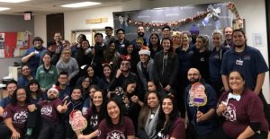 A diverse group of students from CBD College's Student Occupational Therapy Association gather together, smiling and posing for a photo, representing unity and collaboration in advocacy and community engagement efforts.