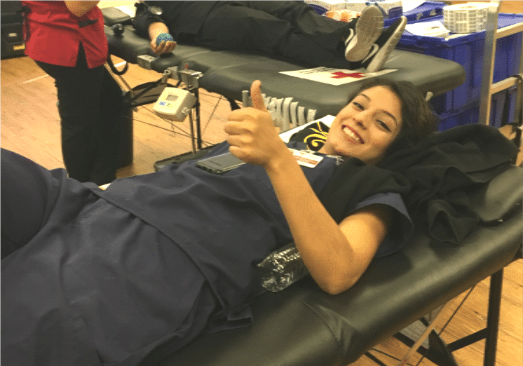 Close-up image of a donor giving blood at CBD College's blood drive.