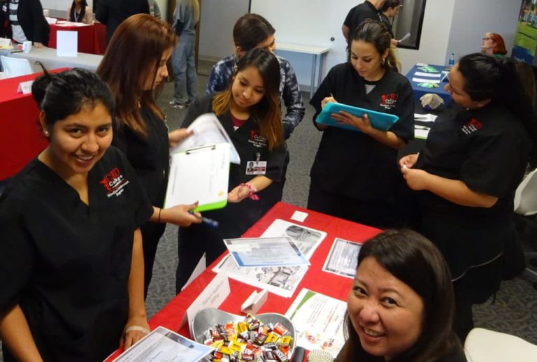 Employers and students discussing potential job opportunities at the CBD College career fair, fostering networking and professional connections.