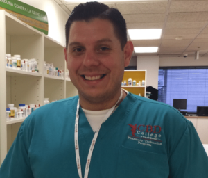 Photo of Danny, a student in the Pharmacy Technician program at CBD College, engaged in hands-on learning and training.