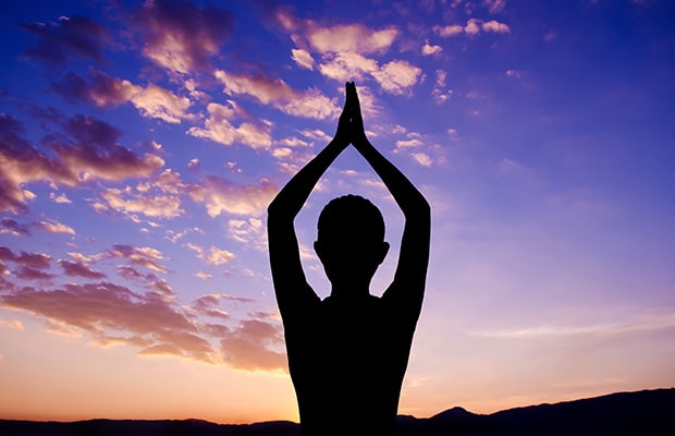 A person standing tall with feet together or slightly apart, arms relaxed by their sides, palms facing forward. Shoulders rolled back, chest open, spine elongated, chin parallel to the floor. Legs engaged, weight evenly distributed across the feet. Overall posture exudes stability, strength, and inner calm.