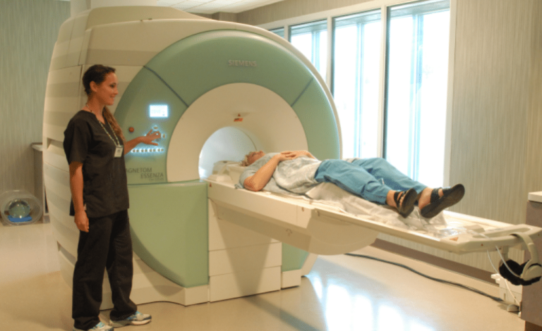 MRI technician operating the machine while a patient undergoes a scan, ensuring accurate imaging results.