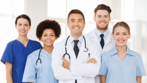 A diverse group of doctors and medical assistants collaborating in a hospital setting, working together to provide quality patient care.
