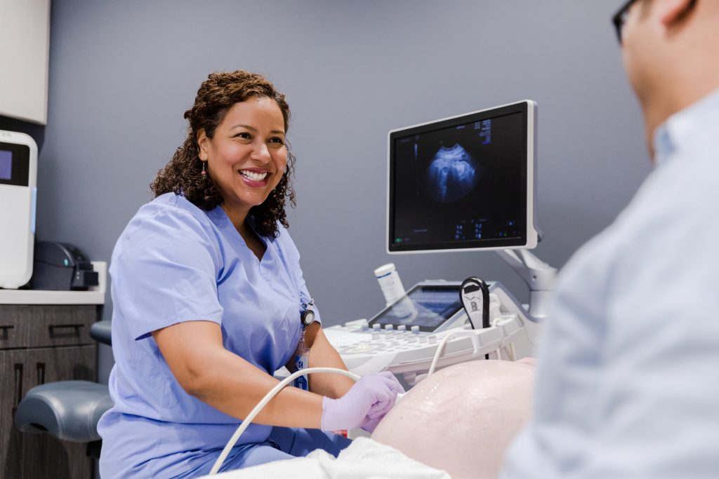 sonographer training on test subject in vocational class